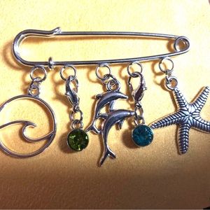 NWT, Handmade by A Charmed Life. Silver seashore charms on a silver pin